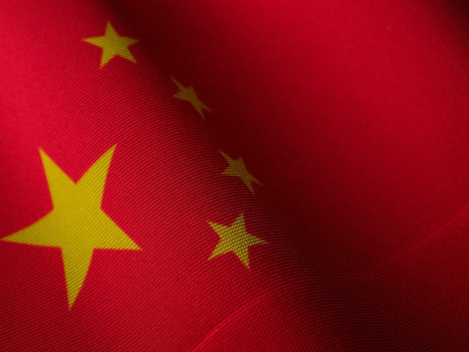 Flag of China as leading AI chatbots including OpenAI's ChatGPT, Microsoft's Copilot, Google's Gemini, DeepSeek's R1, and xAI's Grok are caught reproducing Chinese Communist Party (CCP) propaganda and censorship when questioned on sensitive topics.